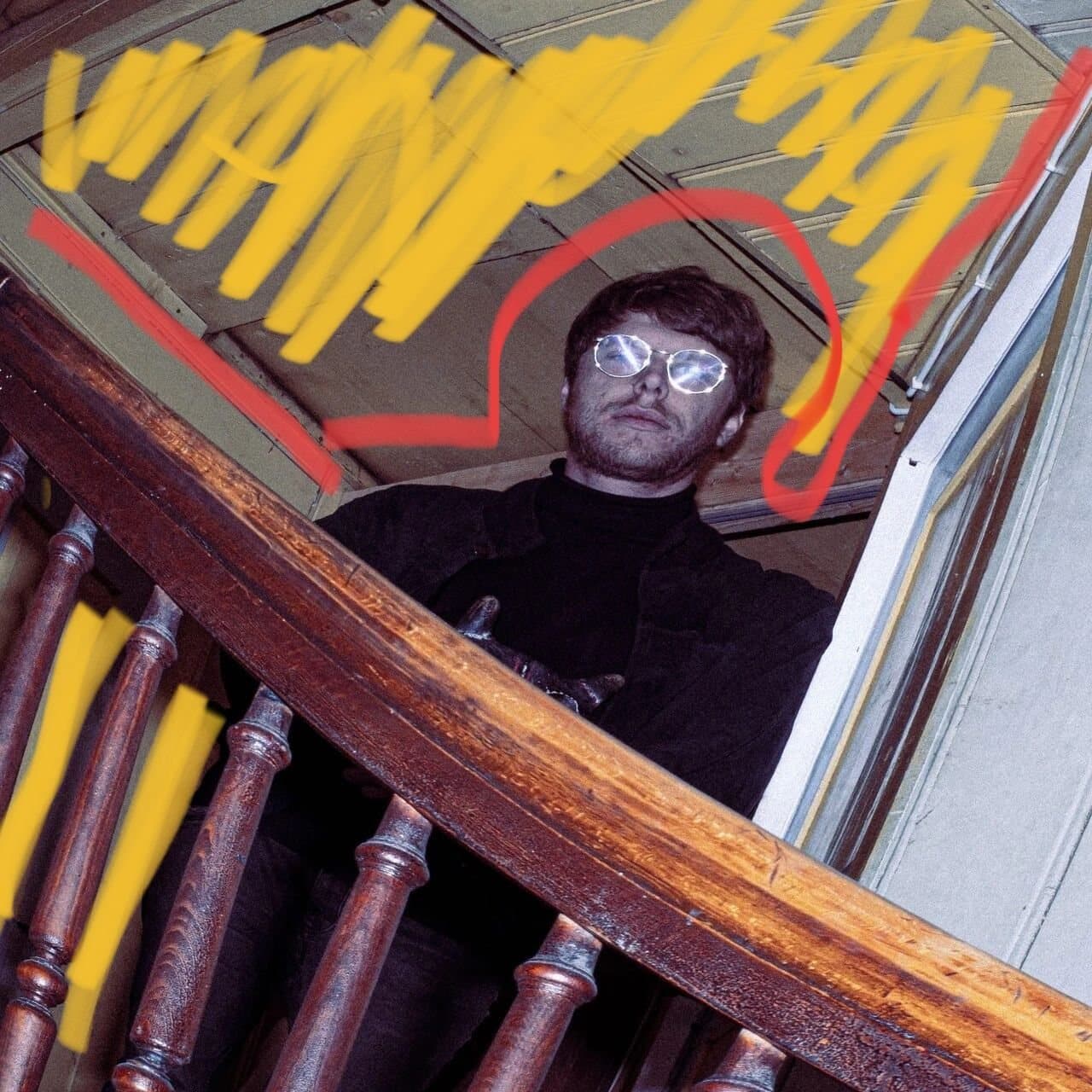 Carlo Onda in sunglasses on a wooden staircase, with yellow and red scribbles over the photo